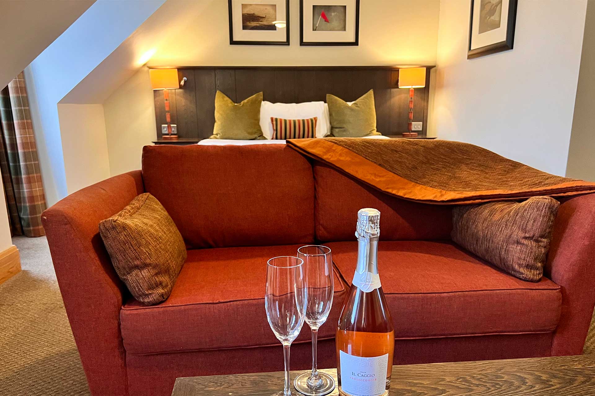 Bedroom at The Loans Inn with bottle of bubbly in foreground